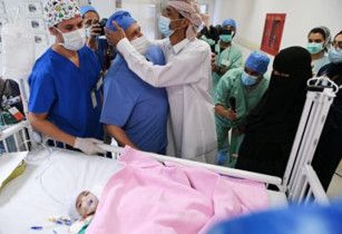 A handout picture provided by the King Salman Humanitarian Aid and Relief Centre on July 31, 2021 shows the father of a pair of Yemeni parasite twin Aisha thanking surgeons after the successful surgery to separate his daughter, at the King Abdullah Specialist Children's Hospital located in the King Abdul Aziz Medical City, in Saudi Arabia's capital Riyadh on July 28.