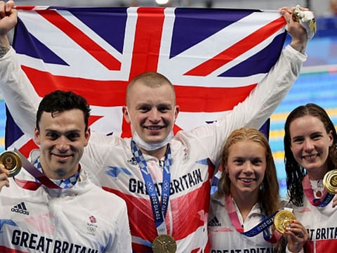 Gold medalists James Guy, Adam Peaty, Anna Hopkin and Kathleen Dawson of Britain celebrate.