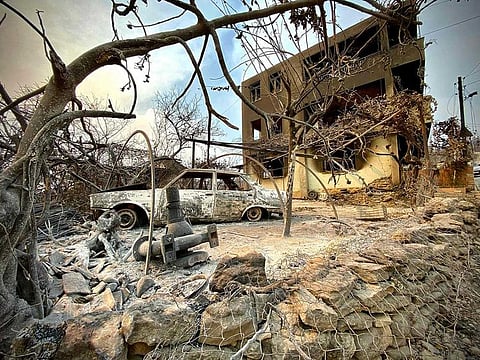 This photograph taken on July 31, 2021 near the town of Manavgat shows burnt car in front of a burnt house as a massive forest fire which engulfed a Mediterranean resort region on Turkey's southern coast. At least three people were reported dead on July 29, 2021 and more than 100 injured as firefighters battled blazes engulfing a Mediterranean resort region on Turkey's southern coast.