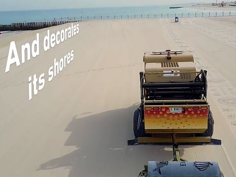 Sand scraper machines are decorating Dubai beaches with the Expo 2020 Dubai logo