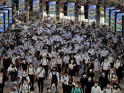 Commuters wearing face masks arrive at Shinagawa Station at the start of the working day amid the coronavirus disease (COVID-19) outbreak, in Tokyo, Japan, August 2, 2021.