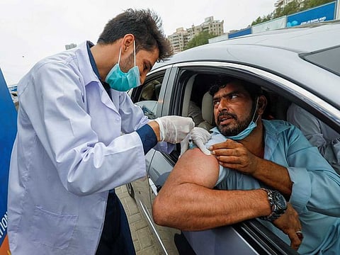 A resident receives a vaccine against coronavirus disease (COVID-19) at a drive-through vaccination facility in Karachi, Pakistan July 29, 2021.