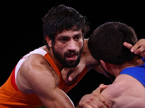 Ravi Kumar Dahiya of India (left) went down to two-time world champion Zavur Uguev of the Russian Olympic Committee in their 57 kg class freestyle bout in Tokyo.
