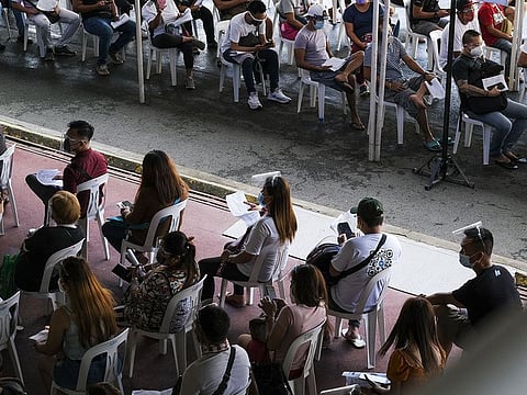 Members of the public wait at a Covid-19 vaccination site set up inside the Marikina Sports Complex in Marikina City, Metro Manila, the Philippines.