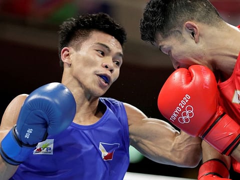 Carlo Paalam of the Philippines in action against Ryomei Tanaka of Japan.