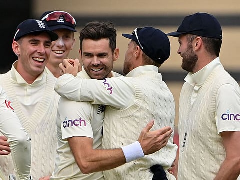 England's swing ace James Anderson (centre) celebrates with teammates after taking the wicket of India's topscorer KL Rahul for 84 on the third day of the first Test match at the Trent Bridge cricket ground in Nottingham on Friday.