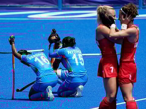 India's Vandana Katariya (16) and India's Nisha (15) kneel (left) on the field after losing their women's field hockey bronze medal match against Britain at the 2020 Summer Olympics, in Tokyo, Japan.