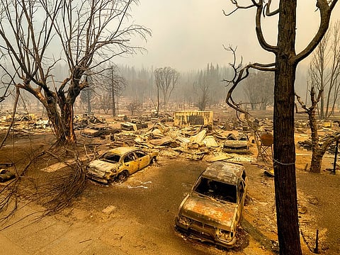 This photo shows cars and homes destroyed by the Dixie Fire line central Greenville, in Plumas County, California.