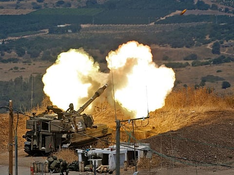 Israeli self-propelled howitzers fire towards Lebanon from a position near the northern Israeli town of Kiryat Shmona following rocket fire from the Lebanese side of the border, on August 6, 2021.