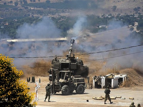 Israeli self-propelled howitzers take position in the northern town of Kiryat Shmona following rocket fire from Lebanon.