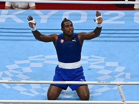 Cuba's Julio la Cruz celebrates winning Olympic gold in the men's heavyweight division.