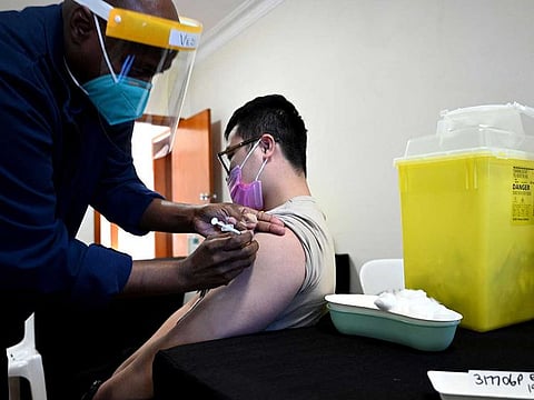 A resident receives his first dose of the AstraZeneca vaccine at a walk-in COVID-19 vaccination centre in the Bankstown suburb of Sydney on August 7, 2021, as Australia's state of New South Wales reported another record day of infections.
