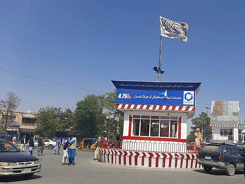 A Taliban flag flies in the main square of Kunduz city after fighting between Taliban and Afghan security forces, in Kunduz, Afghanistan, Sunday, Aug. 8, 2021.