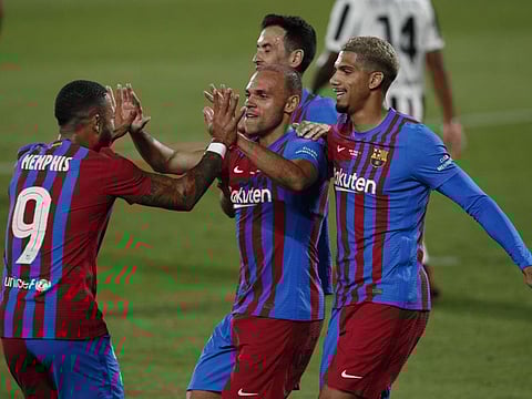 Barcelona's Martin Braithwaite celebrates scoring their second goal with teammates Memphis Depay and Ronald Araujo.
