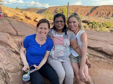 In this Tuesday, Aug. 3, 2021, photo provided by Shaji John, John's wife, Minnie John, center, poses with actress Julie Bowen, right, and Bowen's sister, Dr. Annie Luetkemeyer, left, after the pair cared for her after she fainted and hit her head on a rock while stopping to rest in Arches National Park, Utah.
