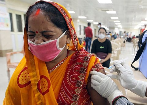 A woman receives a dose of the COVID-19 vaccine during a mega vaccination drive, at Motilal Nehru Medical College, in Prayagraj on August 3.