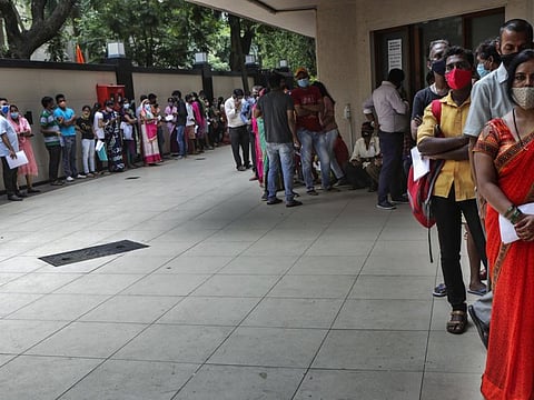 People wait for vaccination in Mumbai, on August 9, 2021.