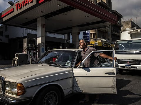 A man who had driven from hours away to find gas pushes his Mercedes past a closed gas station in Dora, Lebanon, outside Beirut. Across Lebanon, fuel shortages have led to long lines at gas stations, where drivers wait for hours to buy only a few gallons, or none at all if the station runs out.