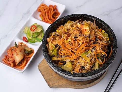 A step-by-step guide to making Korean bibimbap, a healthy assortment of rice, vegetables, minced beef and egg mixed in red chili pepper sauce.