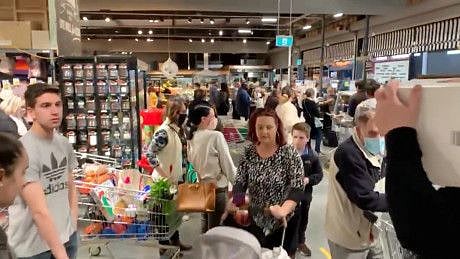 People queue at the Casey Market Town, in Canberra on August 12, 2021 in this screen grab taken from a video. Canberra residents can only leave home for essential reasons from 5pm on Thursday, general retail stores will be closed and hospitality venues will only to able to sell takeout.