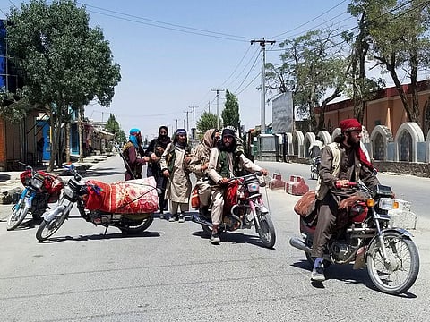 Taliban fighters patrol inside the city of Ghazni, southwest of Kabul, Afghanistan, Thursday, Aug. 12, 2021.
