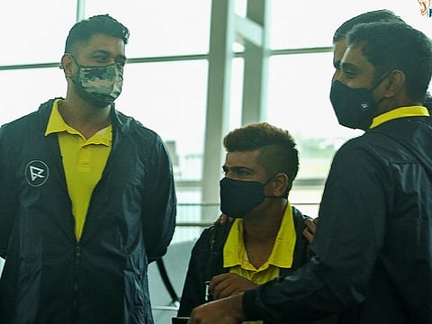 Chennai Super Kings captain Mahendra Singh Dhoni (left) with teammates Ambati Rayudu & Karn Sharma on the eve of their departure for Dubai on Friday.