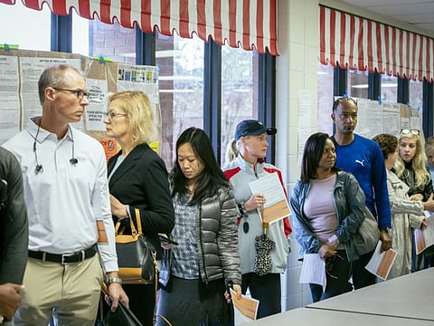 Voters wait in line to cast their ballots at a polling place set up in Hull Middle School in Duluth, Georgia, in a file photo. Overall population growth slowed substantially over the past decade, but the number of multiracial Americans more than doubled.