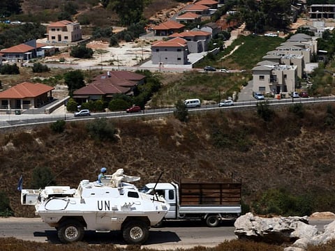 A picture taken from southern Lebanon's Khiam plain, shows a United Nations Interim Force in Lebanon (UNIFIL) military vehicle patrolling near the Israeli northern border town of Metulla, on August 7, 2021.