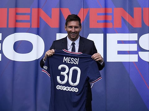 Lionel Messi holds his PSG jersey at the Parc des Princes stadium in Paris following his move from Barcelona.
