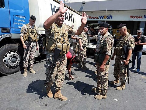 Lebanese army soldiers inspect a gas station, as fuel crisis worsens, in Sidon, Lebanon August 14, 2021.