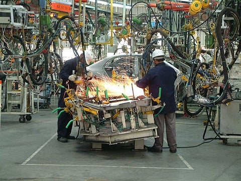 Workers at an auto  manufacturing plant.  Supported by policies on  investment, infrastructure  and labour reforms, the  environment for fostering  industrial growth has  increased greatly