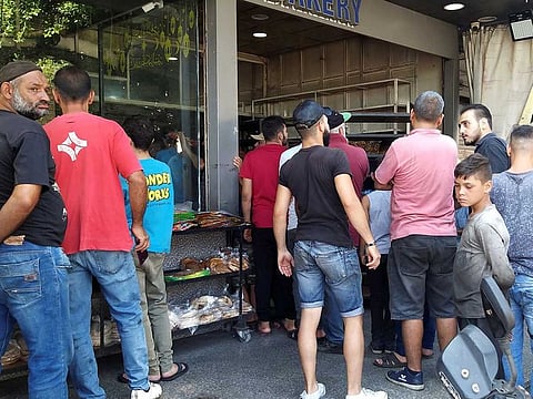 People queue to buy bread from a bakery in Tripoli, Lebanon. “Not only has the share of poor Lebanese nationals tripled to 33 per cent from a decade ago, but they have also fallen deeper into poverty with the poverty gap rising,” the report said.