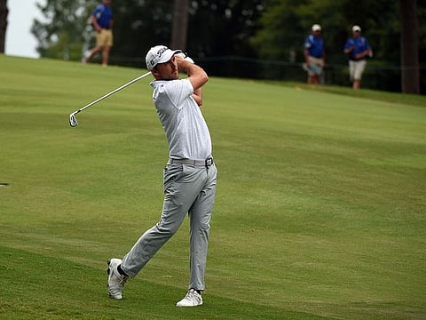 Russell Henley hits his approach shot on the 18th hole during the third round of the Wyndham Championship