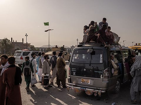 People prepare to flee Kabul ahead of Taliban fighters arriving in Kabul, Afghanistan, Aug. 15, 2021.