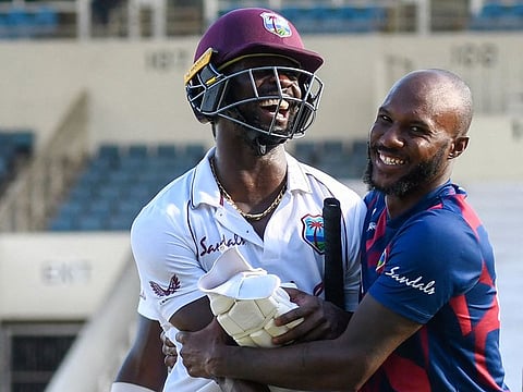 Kemar Roach (L) and Jermaine Blackwood (R) of West Indies celebrate winning on day 4 of the 1st Test between the West Indies and Pakistan at Sabina Park, Kingston, Jamaica, on August 15, 2021.