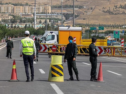 Iranian policemen man a checkpoint on a highway in Tehran leading to the country's north, on August 16, 2021, at the start of a new 5-day lockdown to mitigate the spread of the virus.