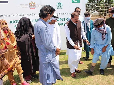 UAE ambassador to Pakistan Hamad Obaid Ibrahim Al Zaabi with people who have been provided artificial limbs by the UAE Embassy and the Pakistan Bait-ul-Mal at the embassy in Islamabad on Tuesday, August 17, 2021.