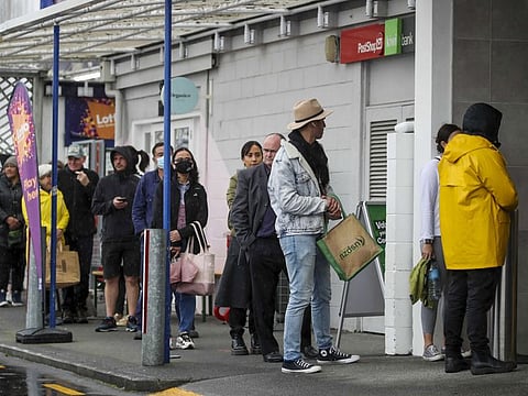 Shoppers lineup at a supermarket in Auckland on August 17, 2021. Prime Minister Jacinda Ardern has announced New Zealand will go to a level four lockdown from 11.59pm Tuesday after the discovery of community a case of COVID-19.