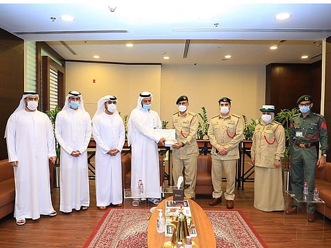 Mohammad Saleh Al Waqdi (fourth from left) was honoured by Dubai Police for returning bag full of cash