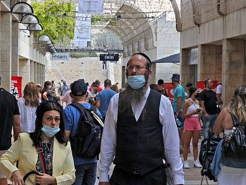 People at a market in Jerusalem, on August 11, 2021. The rise in infections in Israel is a step back after its world-leading vaccine campaign drove down new COVID-19 cases from 10,000 a day to fewer than 100.