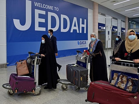 Pilgrims arrive at King Abdul Aziz International Airport in the Red Sea coastal city of Jeddah on August 15, 2021, as Saudi Arabia allows vaccinated foreigners to make the Umrah pilgrimage nearly 18 months after it closed its borders to battle coronavirus.