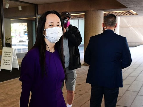 Huawei Chief Financial Officer Meng Wanzhou leaves the British Columbia Supreme Court with her security detail on August 18, 2021, in Vancouver, Canada, after her last extradition hearing.