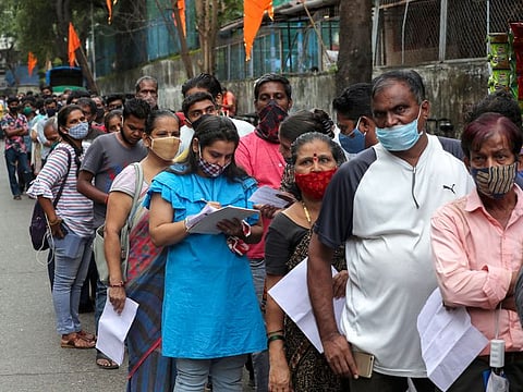 People queue up to get inoculated against COVID-19 at a vaccination centre in Mumbai, India, on August 17, 2021.