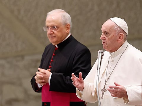 Pope Francis, flanked at left by Monsignor Leonardo Sapienza, attends his weekly general audience in the Paul VI Hall at the Vatican, on August 11, 2021.