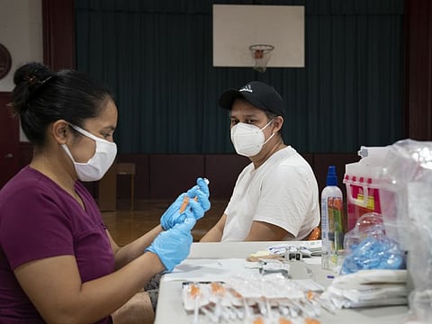 A medic prepares to vaccinate a man in the Bronx borough of New York. The Centers for Disease Control and Prevention released three studies on August 18 as evidence that booster shots of the Pfizer-BioNTech and Moderna vaccines would be needed in the coming months.
