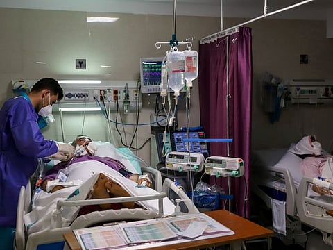An Iranian nurse checks on COVID-19 patients at a hospital in Tehran in a file photo.