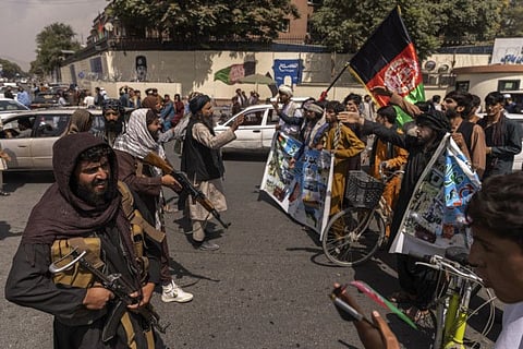 Taliban gunmen confronted protesters carrying the flag of the deposed Afghan government in Kabul on August 19, 2021.