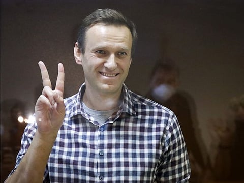 Russian opposition leader Alexei Navalny gestures as he stands in a cage in the Babuskinsky District Court in Moscow in a file photo.