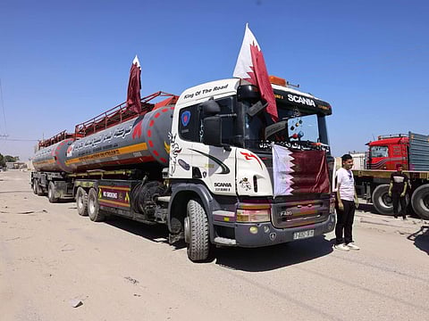 A truck with Qatari flags transporting fuel for Gaza's sole power plant arrives to the Rafah crossing in the southern Gaza Strip in a file photo. Israel on August 19, 2021 announced a "new mechanism" for Qatari humanitarian funds to reach Gaza.