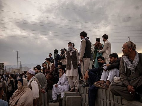 Hoping to flee the country, people gather outside the airport in Kabul, Afghanistan on Friday, Aug. 20, 2021.